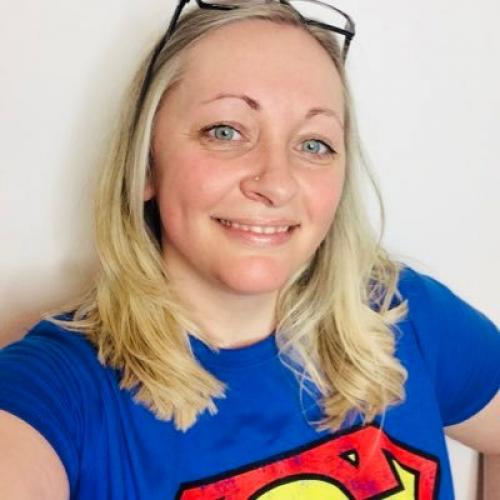 Headshot of Kirsten Thompson in a Superman t-shirt